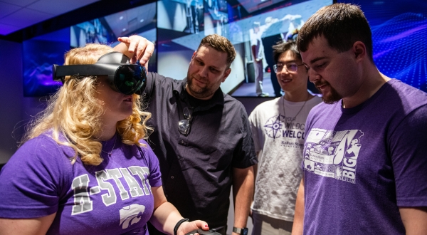 A K-State Salina instructor shows students how to wear a VR headset. 