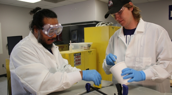 A student and instructor work on a composites mold at the K-State Salina campus.