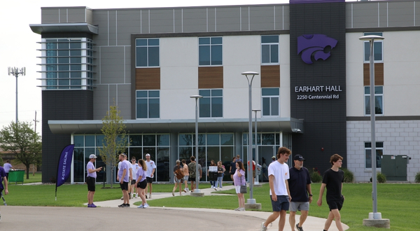 Students mill about the K-State Salina campus in front of one of the residence halls, Earthart Hall
