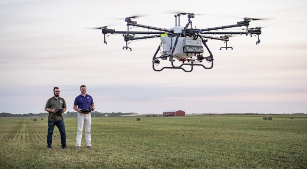 A K-State Salina UAS instructor teaches a trainee how to operate a drone over a pasture. The Applied Aviation Research Center provides unrivaled training in utilizing drone services for agriculture. 