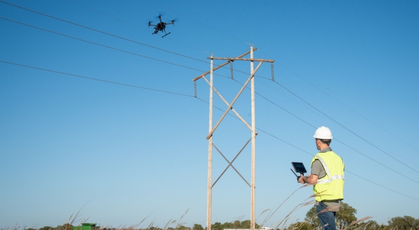 A drone operator flies the technology near a powerline to make inspections. K-State Salina's UAS experts provide training that engineers and utility provides can utilize.