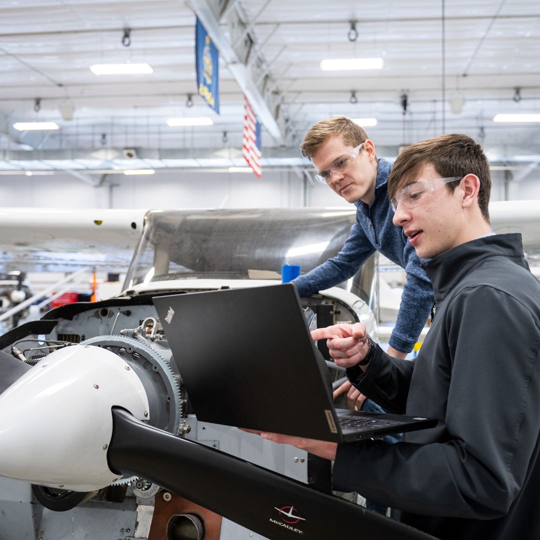 Students working on airplane