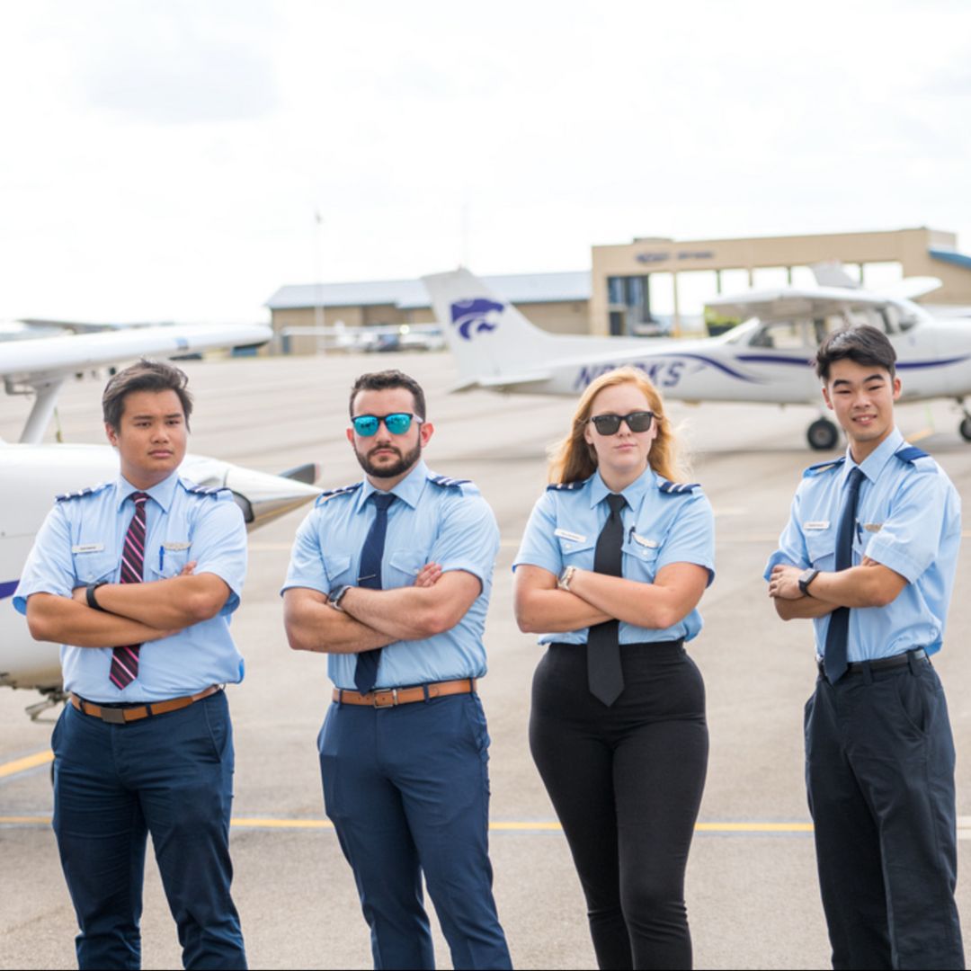 Flight students standing in front of airplane