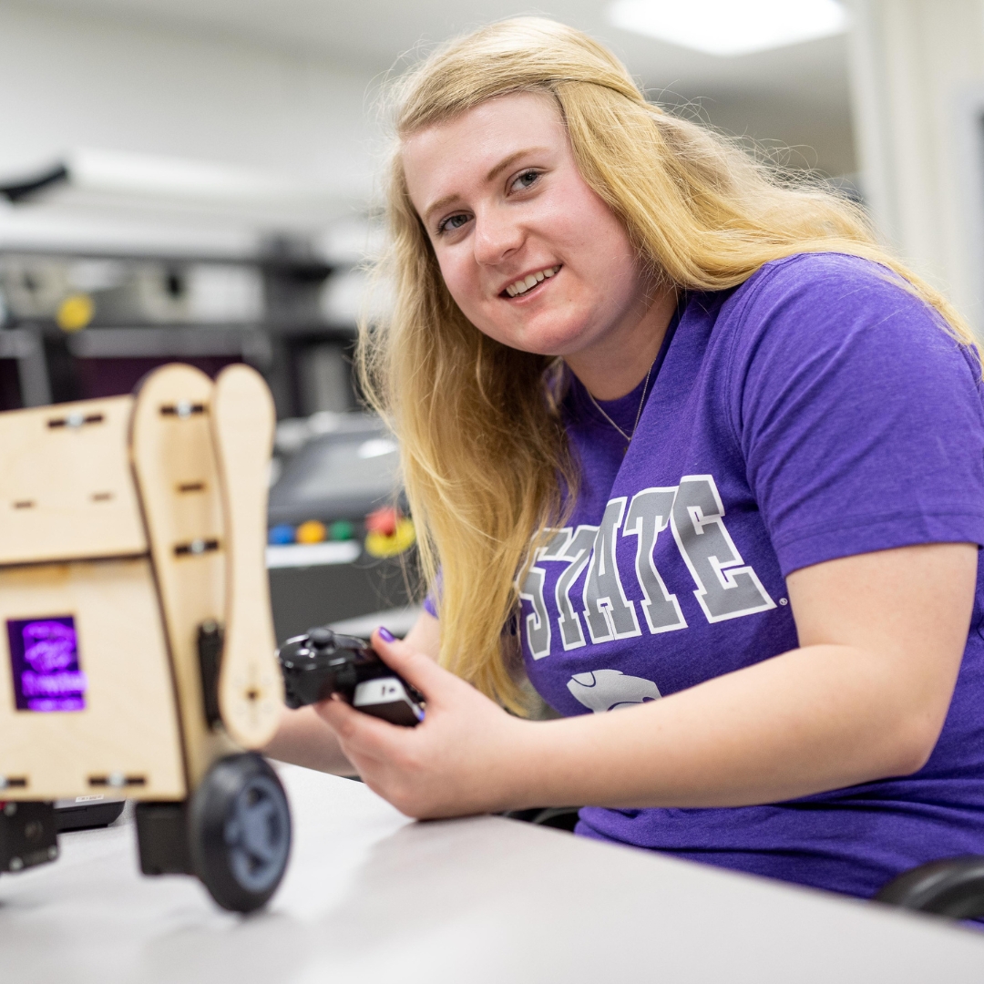 Student operating small robot